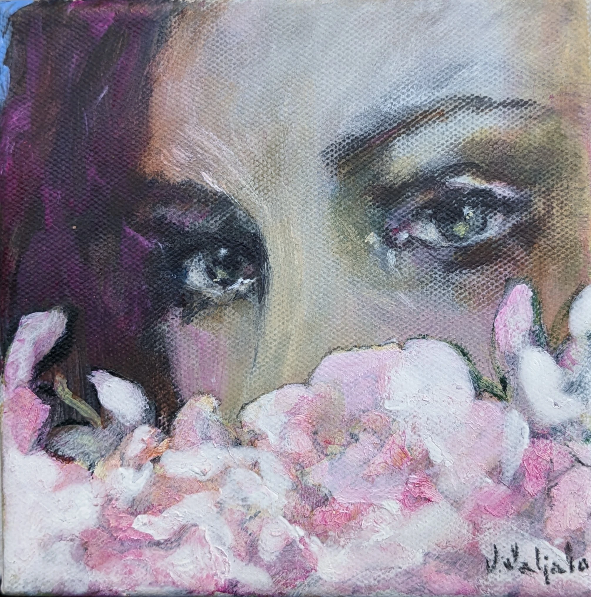 A close view of a woman’s eyes above pale pink and white flowers.