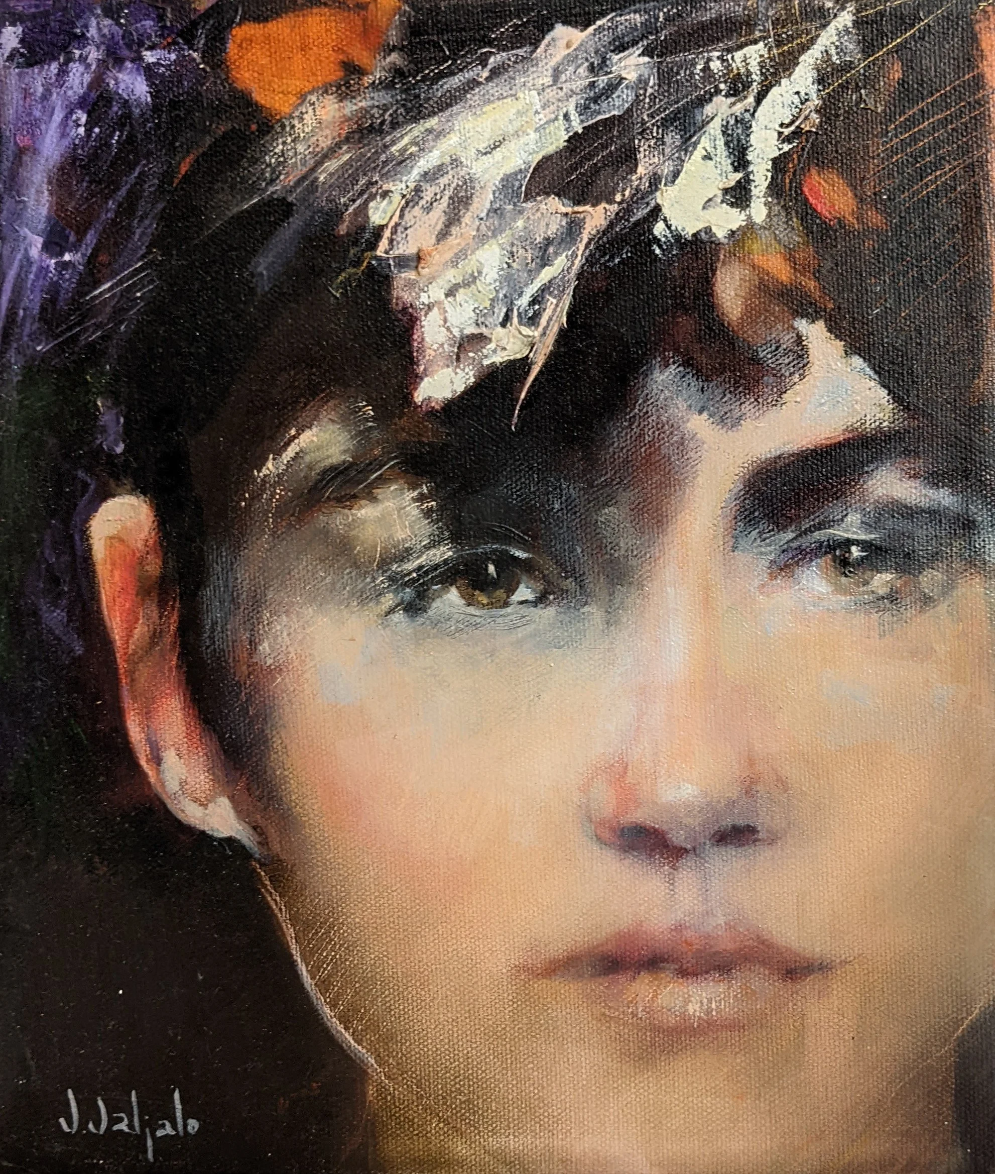 A front-facing woman with short dark hair beneath loose white and orange marks.